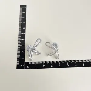 Chic bow clip-on earrings with sparkling cubic zirconia, elegant and minimalist jewelry design.