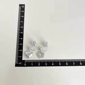 Silver clip-on earrings with heart and flower charms, minimalist sweet style non-pierced jewelry.