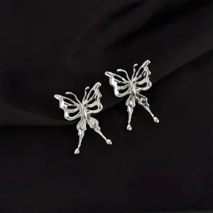 Close-up detail shot of silver liquid metal butterfly clip earrings with stylish Y2K aesthetic.