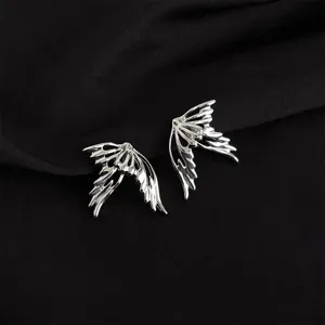 Detailed shot of edgy silver wing ear clips, showcasing intricate cutout feather details.
