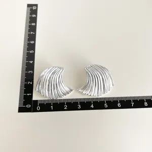Silver wave clip-on earrings for women, stylish metal non-pierced ear jewelry, daily wear.