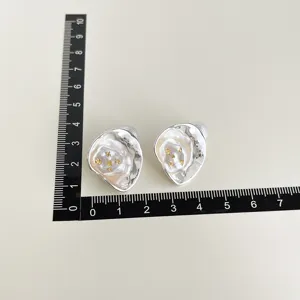 Irregular metal clip-on earrings with gold flake details, elegant and unique design for daily wear.
