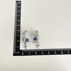 Silver clip-on earrings with blue cubic zirconia moon and star design for non-pierced ears.