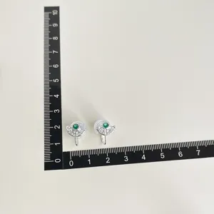 Non-pierced clip-on earrings with sparkling cubic zirconia and green center stone for women.