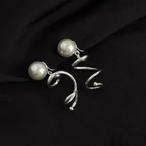 Detail shot of non-pierced spiral coil earrings with faux pearls, sweet and cool style.