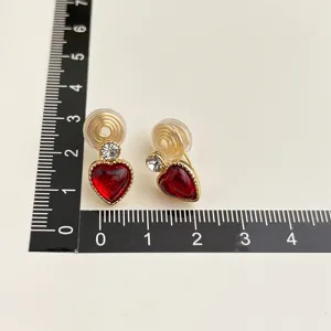 Chic red heart clip-on earrings with shimmering rhinestones and gold-tone finish for women.