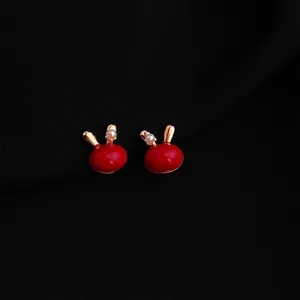 Elegant wine red enamel bunny ear clip earrings with pearl detail, chic gold-plated jewelry for women.