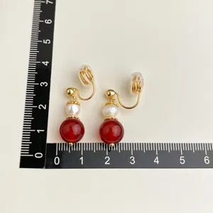 Elegant vintage clip-on earrings with pearl and red gemstone, gold-plated design for women.