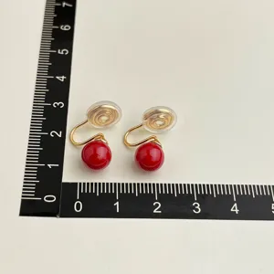 Vintage wine red beaded clip-on earrings with gold tone mosquito coil tray design.