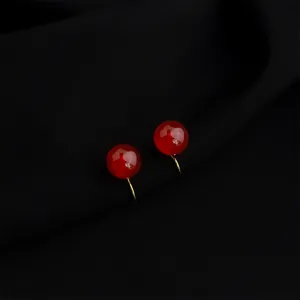Red bead clip earrings detail shot, elegant wine red color with gold tone fittings.