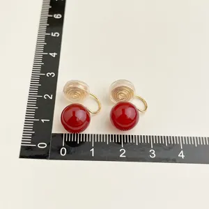 Wine red clip-on earrings with gold plated coil design, elegant retro style jewelry.