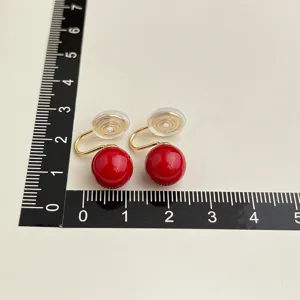 Detailed size view of wine red clip-on earrings, vintage gold plated non-pierced jewelry.