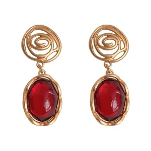 Vintage gold tone clip-on earrings with faceted red stone drop elegant retro jewelry