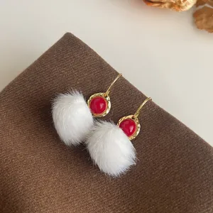 Schicke weiße Plüsch-Bommel-Ohrringe mit rotem runden Stein und goldenem strukturierten Rand.