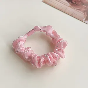 Pink satin hair scrunchie with rhinestone embellishments, elegant elastic hair tie accessory.