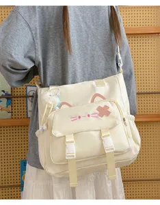 Detailed shot of a cute Japanese style beige canvas shoulder bag with cat ear design.