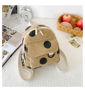 Corduroy mini backpack detail, beige fabric with black polka dots, daily cute casual style.