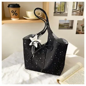 Black star print tote bag with bow detail and star charm for daily casual commuting use.