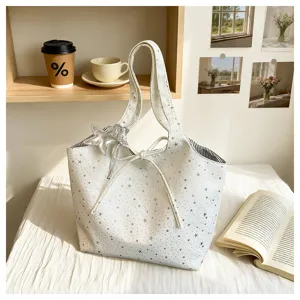 Detailed view of white star print tote bag with cute star charm, casual daily commuting style.