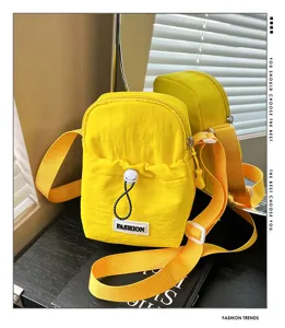 Yellow crossbody phone bag detail showing drawstring closure and stylish fabric texture.