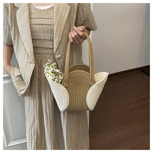 Detailaufnahme einer stilvollen geflochtenen Handtasche mit einzigartigem Bogen und Farbmix.