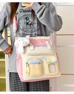 Bolso bandolera de lona estilo universitario japonés con colgante de gato y gran capacidad.
