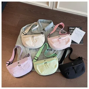 Casual nylon sling bag for women, trendy crescent crossbody shoulder bag in multiple colors.