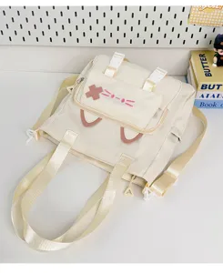 Cute Japanese style canvas shoulder bag with cat ear embroidery, casual student crossbody tote.