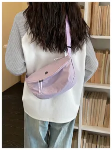 Casual nylon belt bag worn crossbody, showing lavender color and back detail view clearly.