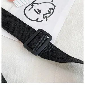 Detailed view of the black canvas bag strap with adjustable buckle, durable hardware.