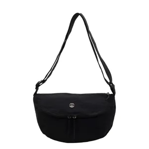 Black nylon casual crossbody bag for women, stylish crescent shoulder bag with metal logo.