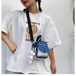Canvas crossbody bag detail showing blue white colorblock design and cute bear pendant.