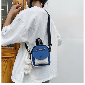 Canvas crossbody bag for women, casual mini backpack with cute bear pendant and stylish letter print.