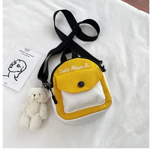 Fashion canvas crossbody bag for women, cute contrast color mini shoulder bag with bear pendant.