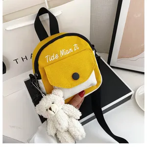 Stylish canvas small crossbody bag for women, cute yellow and white contrast design with bear pendant.
