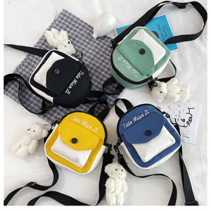 Canvas crossbody bag with cute bear pendant, mini flap shoulder bag for women and girls.