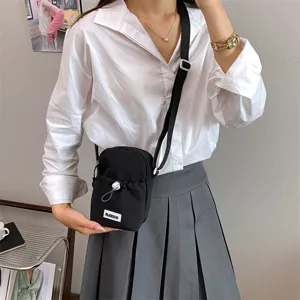 Black nylon crossbody phone bag for women, casual small shoulder bag with drawstring.