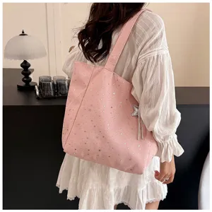 Detailed view of casual pink canvas shoulder tote bag featuring cute silver star print pattern