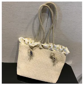 Detailed view of the summer straw woven tote bag featuring stylish yellow gingham ruffle lining.