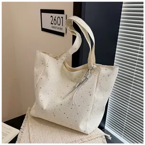 Detail view of white tote bag with silver star print, large capacity casual handbag for women.