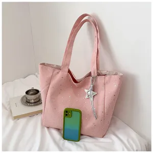 Pink star print tote bag detail showing shoulder strap and hanging star decoration accessory.