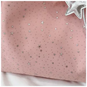 Pink tote bag fabric detail featuring silver stars and dots pattern with cute charm.