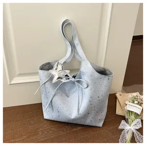 Detailed view of the light blue star print tote bag featuring a cute bow and star pendant.