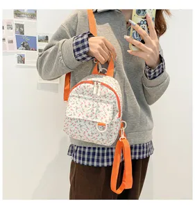 Detailed view of the cute floral mini backpack with orange straps, showcasing sweet design.
