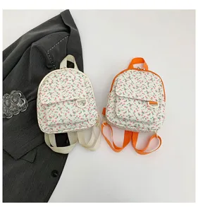 Floral mini backpack detail view showing cute small print, adjustable straps and front pocket.