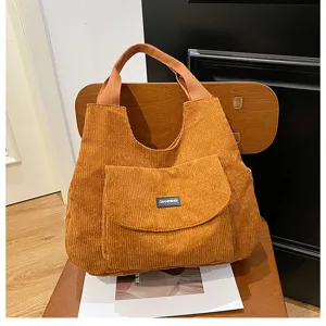 Corduroy shoulder bag for women, casual large capacity tote bag featuring convenient front pocket.