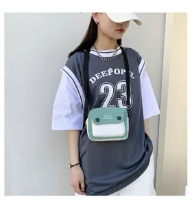 Small canvas crossbody bag worn by model, stylish color-block design for women and girls.