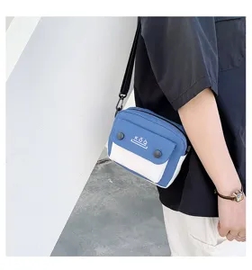 Canvas crossbody bag detail showing blue white color block design and front KōQ pocket.
