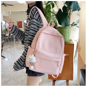 Pink plaid backpack detail view featuring a cute cloud pendant, daily school bag design.