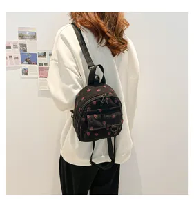 Cute strawberry print corduroy mini backpack for women, stylish college style casual bag.